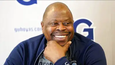 In this Oct. 30, 2018, file photo, Georgetown men's basketball head coach Patrick Ewing smiles during a television interview while speaking about the upcoming season at Georgetown University in Washington.
