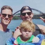 A photo of Christopher Landon (left) and his husband Cody Morris (right) and their son Beau (center)